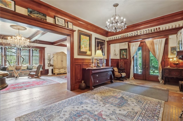 foyer featuring french doors, ornamental molding, an inviting chandelier, hardwood / wood-style floors, and coffered ceiling