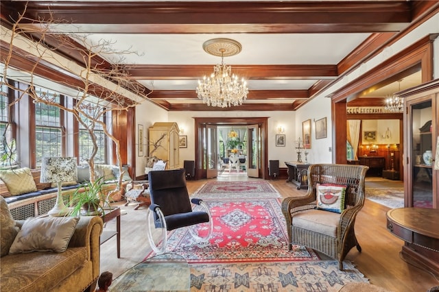 interior space with an inviting chandelier, ornamental molding, beam ceiling, and hardwood / wood-style flooring