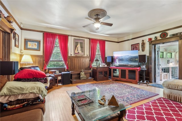 living room with wood-type flooring and ceiling fan