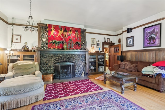 living room with wood-type flooring and a stone fireplace