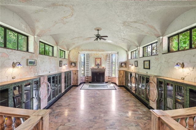 kitchen with a healthy amount of sunlight, ceiling fan, and vaulted ceiling