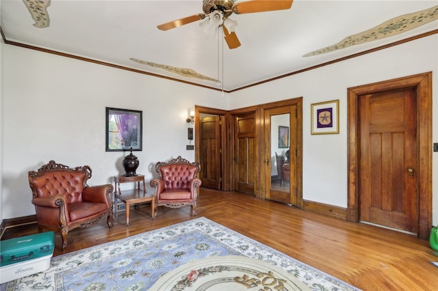 sitting room featuring vaulted ceiling, hardwood / wood-style flooring, ceiling fan, and crown molding