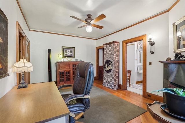 office featuring ceiling fan, hardwood / wood-style floors, and ornamental molding