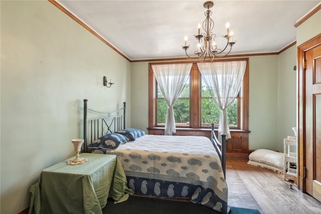 bedroom with a chandelier, ornamental molding, and hardwood / wood-style floors