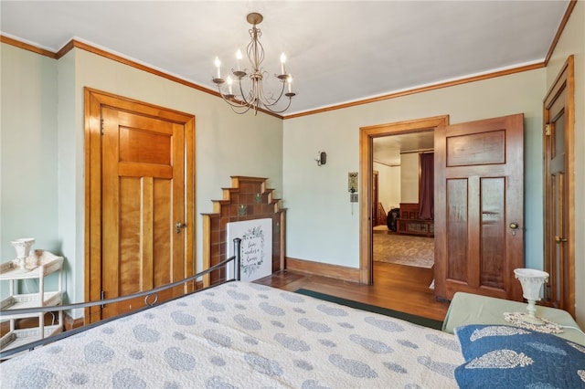 bedroom featuring ornamental molding, an inviting chandelier, and hardwood / wood-style floors