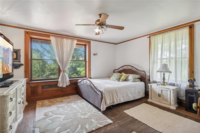 bedroom with ornamental molding, ceiling fan, and dark hardwood / wood-style flooring