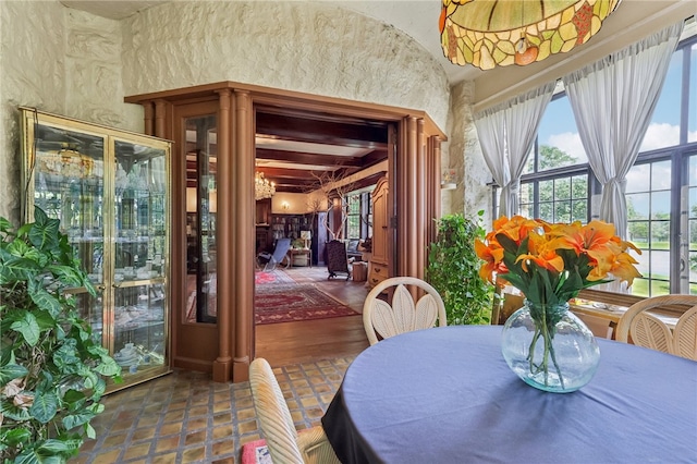 dining room with beam ceiling and hardwood / wood-style flooring