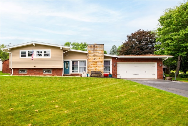 view of front of property with a front yard and a garage