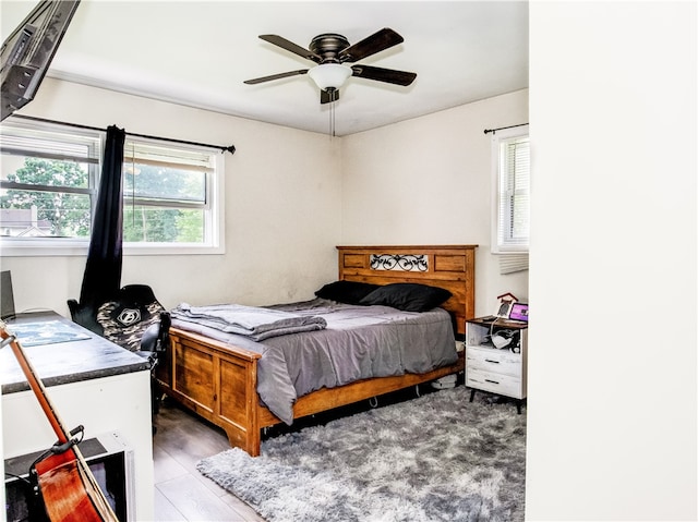 bedroom featuring dark hardwood / wood-style flooring and ceiling fan