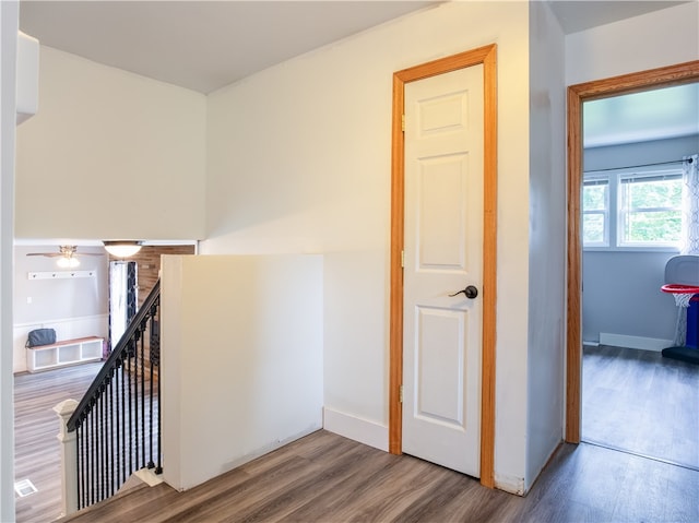 corridor with hardwood / wood-style flooring