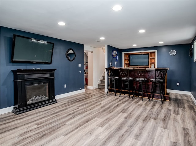 bar with light hardwood / wood-style flooring