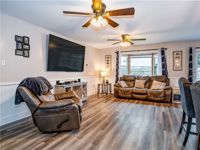 living room featuring ceiling fan and hardwood / wood-style flooring