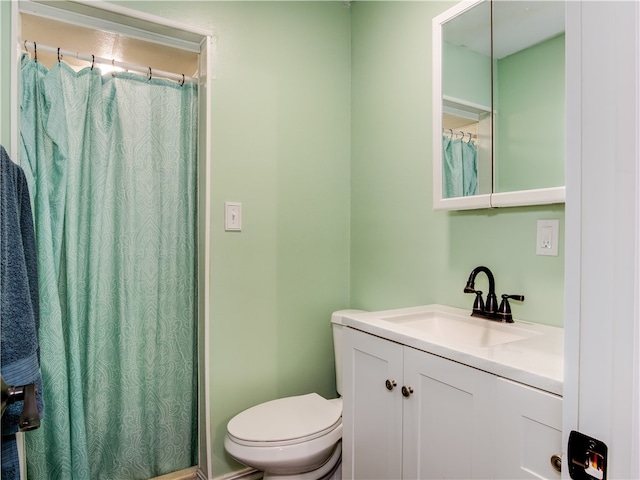 bathroom with vanity, toilet, and walk in shower