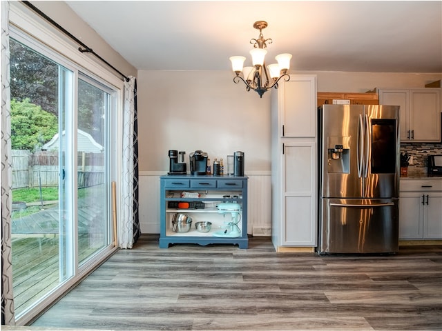 kitchen with white cabinetry, wood-type flooring, stainless steel fridge with ice dispenser, and an inviting chandelier