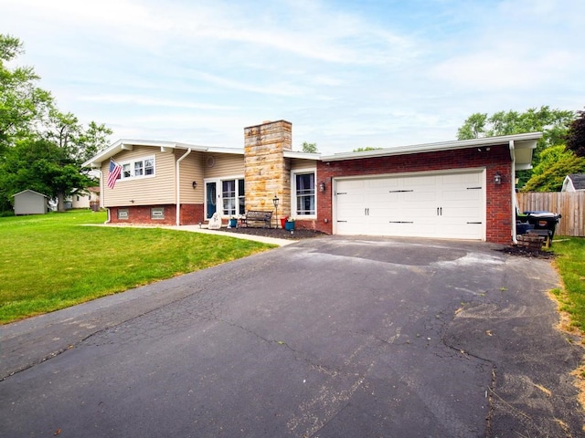 view of front facade with a front yard and a garage