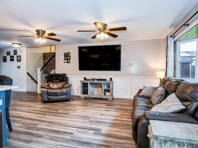 living room featuring hardwood / wood-style floors and ceiling fan