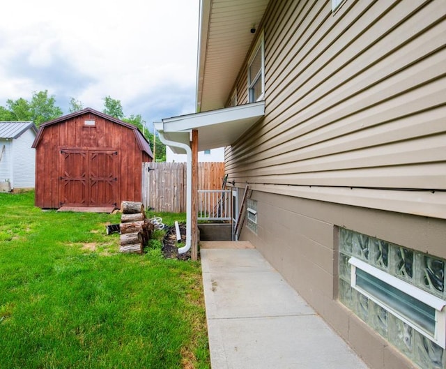 view of side of home featuring a storage shed and a yard