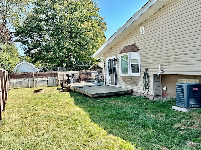 view of yard with a wooden deck and central AC unit