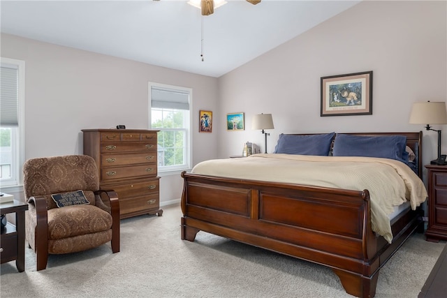 carpeted bedroom with vaulted ceiling and ceiling fan