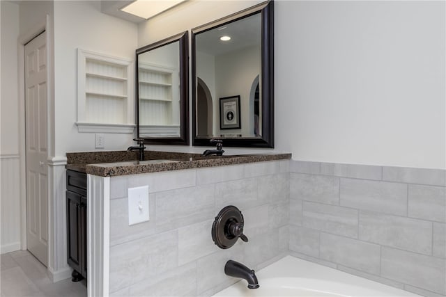 bathroom with shower / washtub combination, tile floors, and large vanity