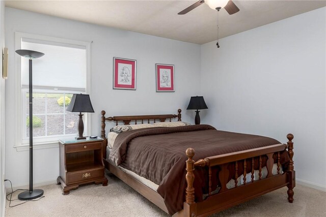 bedroom with ceiling fan and light colored carpet