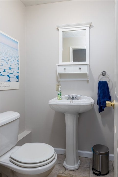 bathroom with tile flooring and toilet