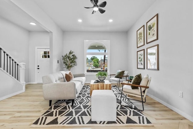 living room with ceiling fan and light wood-type flooring