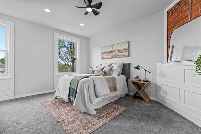 bedroom with dark colored carpet and ceiling fan