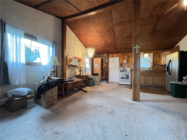 misc room featuring sink, light colored carpet, and high vaulted ceiling