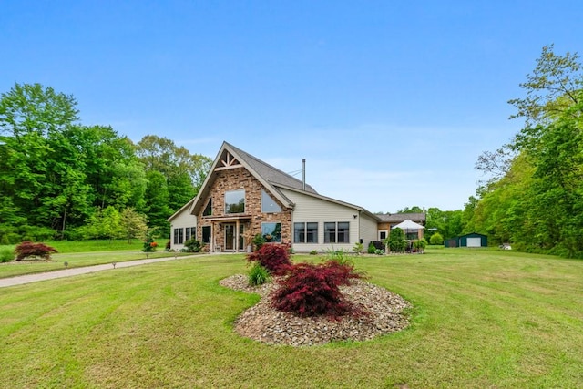 view of front of home with an outdoor structure and a front yard