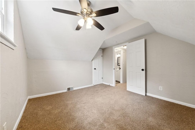 bonus room with light carpet, ceiling fan, and lofted ceiling