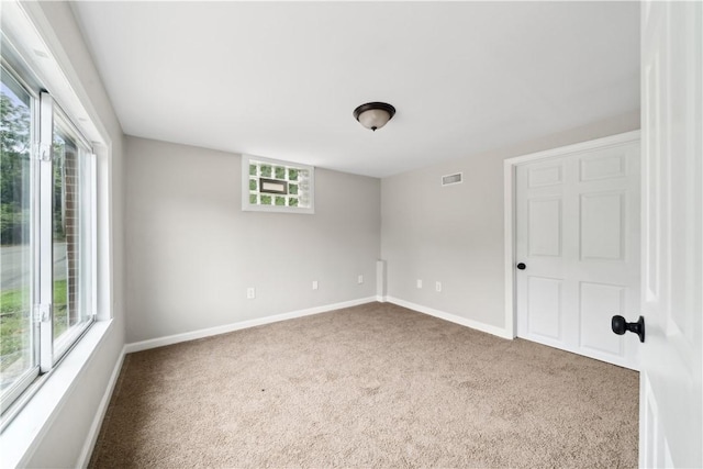 carpeted spare room with plenty of natural light