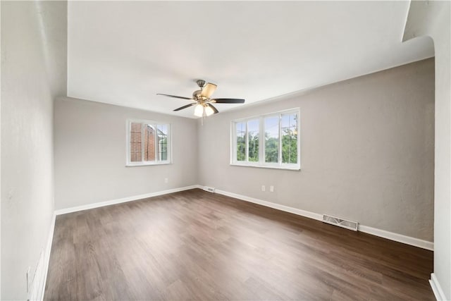 unfurnished room with dark hardwood / wood-style floors and ceiling fan