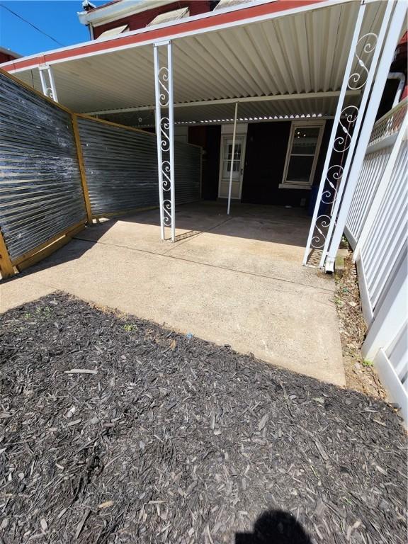 view of vehicle parking with a carport