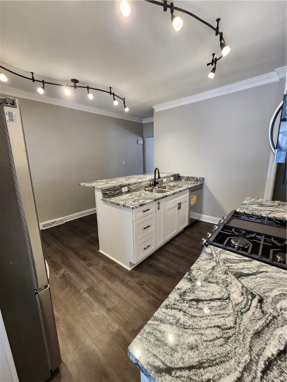 kitchen featuring stainless steel refrigerator, ornamental molding, dark hardwood / wood-style floors, light stone countertops, and white cabinets