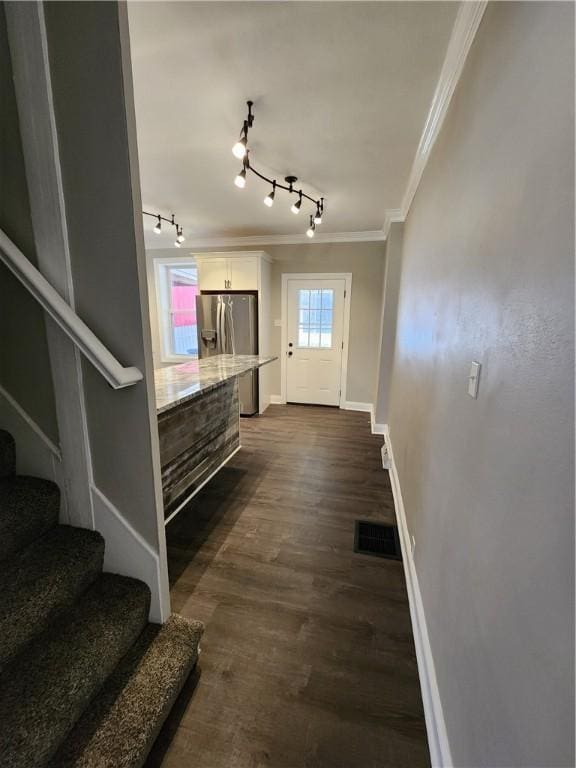 interior space featuring ornamental molding and dark hardwood / wood-style floors