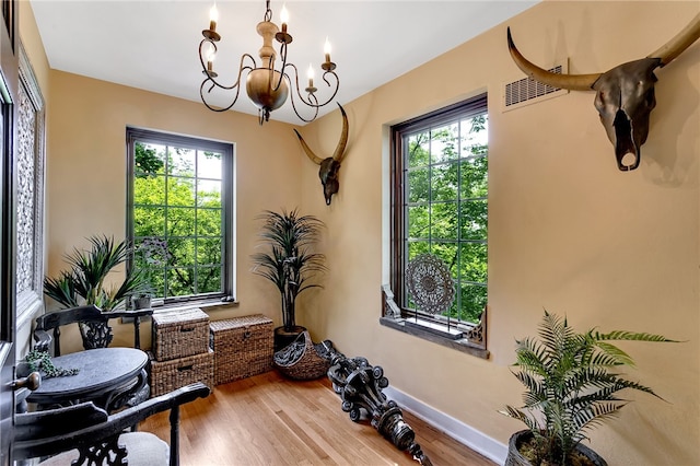 interior space featuring wood-type flooring and an inviting chandelier