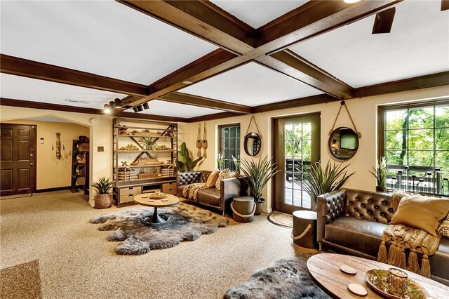 living room with a wealth of natural light, carpet, coffered ceiling, and beam ceiling