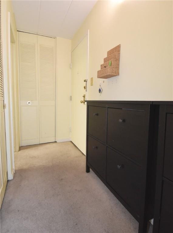 hallway with light colored carpet