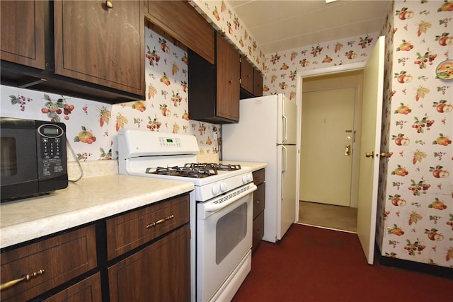 kitchen with white gas range and dark brown cabinetry