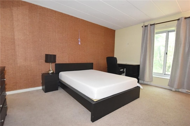 bedroom featuring light colored carpet and multiple windows