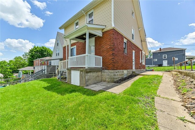 view of side of property with a lawn