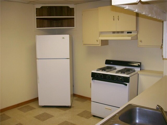 kitchen featuring wall chimney range hood, light tile flooring, white cabinets, sink, and white appliances