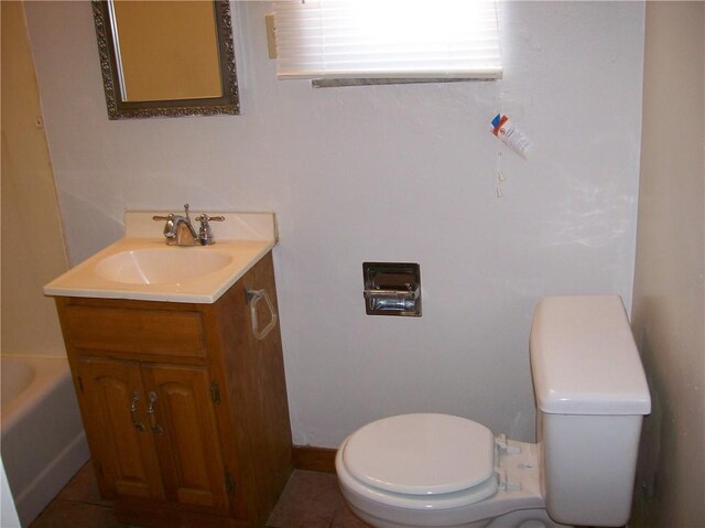 bathroom featuring tile floors, vanity, and toilet