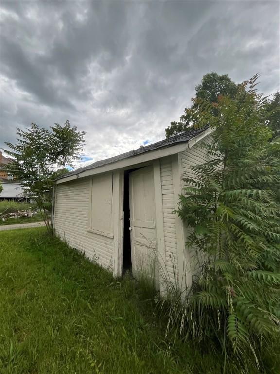 view of outbuilding with a lawn