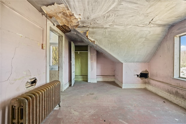 additional living space with lofted ceiling and radiator heating unit