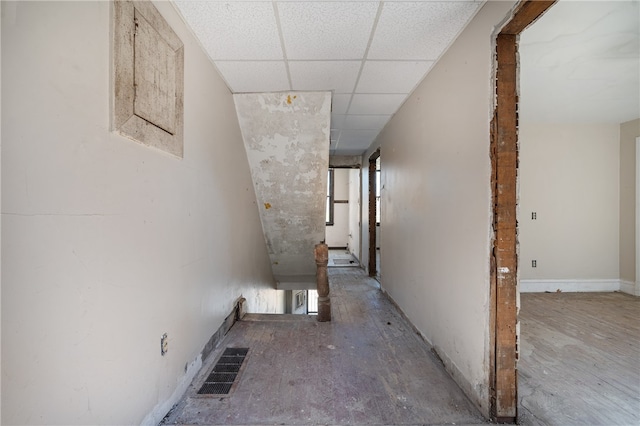 corridor with a paneled ceiling