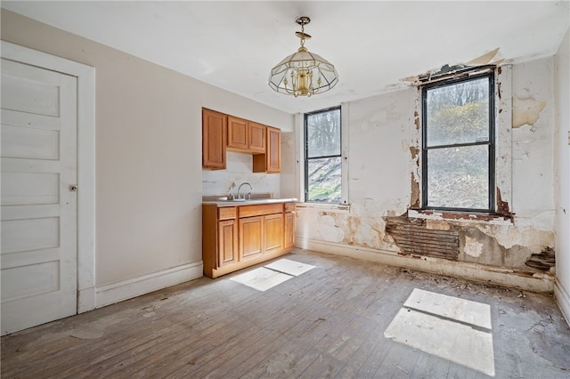 kitchen featuring decorative light fixtures, a notable chandelier, plenty of natural light, and light wood-type flooring