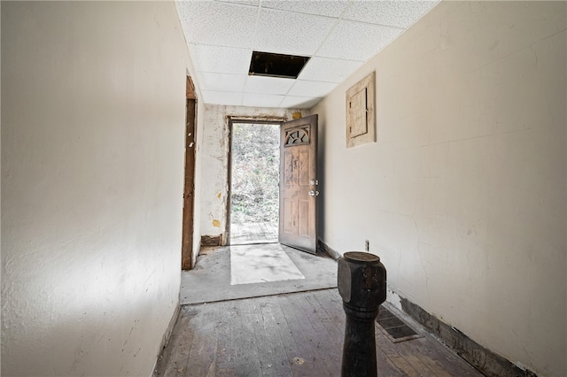 interior space with hardwood / wood-style flooring and a drop ceiling