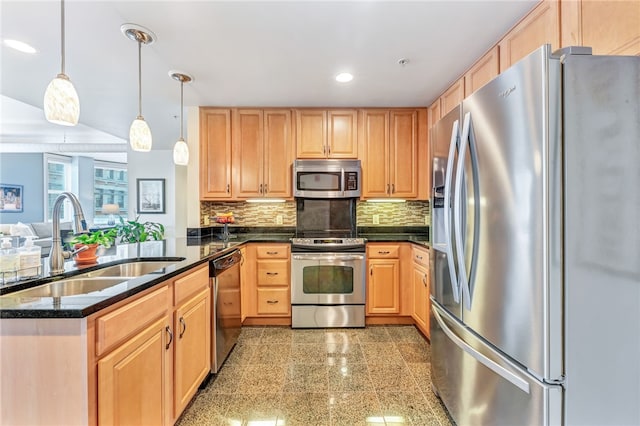 kitchen with kitchen peninsula, tasteful backsplash, decorative light fixtures, sink, and appliances with stainless steel finishes